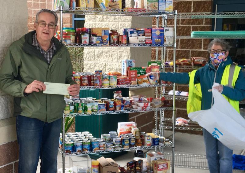 Staffing the Epworth UMC food pantry mobile distribution center are Walt Smith, coordinator of Epworth’s Good Samaritans program, and volunteer Sara Rosen. SUBMITTED PHOTO